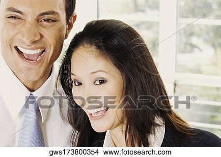 Close-up of a businessman and a businesswoman laughing View Large Photo Image Picture - Close-up of a businessman and a businesswoman laughing. Fotosearch