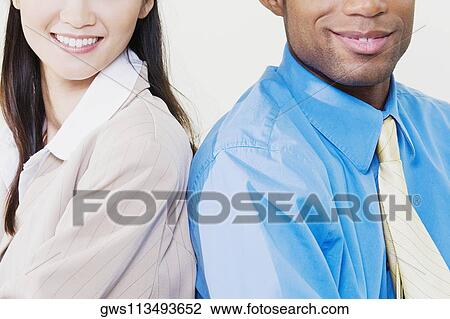 Close-up of a businessman and a businesswoman smiling View Large Photo Image Stock Image - Close-up of a businessman and a businesswoman smiling. Fotosearch