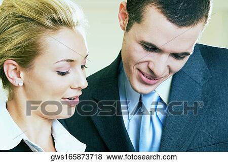 Close-up of a businessman and a businesswoman smiling View Large Photo Image Stock Photo - Close-up of a businessman and a businesswoman smiling. Fotosearch