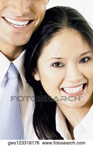 Close-up of a businessman and a businesswoman smiling View Large Photo Image Stock Photograph - Close-up of a businessman and a businesswoman smiling. Fotosearch