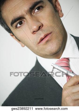 Close-up of a businessman holding a pen View Large Photo Image Stock Image - Close-up of a businessman holding a pen. Fotosearch