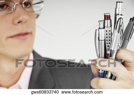 Close-up of a businessman holding pens View Large Photo Image Stock Image - Close-up of a businessman holding pens. Fotosearch