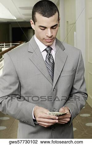 Close-up of a businessman holding US paper currency View Large Photo Image Stock Image - Close-up of a businessman holding US paper currency. Fotosearch