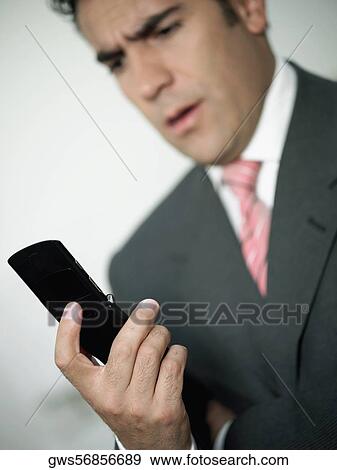 Close-up of a businessman looking at a mobile phone View Large Photo Image Stock Photo - Close-up of a businessman looking at a mobile phone. Fotosearch