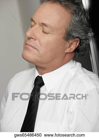Close-up of a businessman looking stressed View Large Photo Image Stock Image - Close-up of a businessman looking stressed. Fotosearch