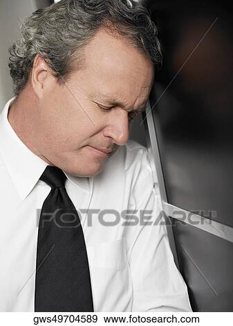 Stock Photo - Close-up of a businessman looking stressed. Fotosearch