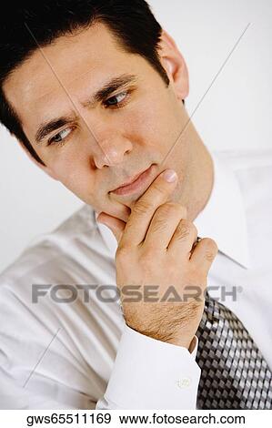 Stock Photo - Close-up of a businessman looking worried. Fotosearch