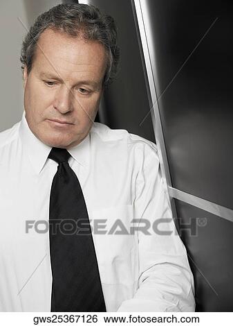 Stock Photograph - Close-up of a businessman looking stressed. Fotosearch