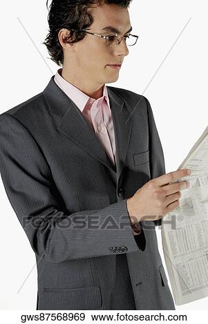 Stock Photo - Close-up of a businessman reading a newspaper. Fotosearch