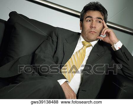 Close-up of a businessman sitting with his legs crossed at the knee View Large Photo Image Stock Photo - Close-up of a businessman sitting with his legs crossed at the knee. Fotosearch