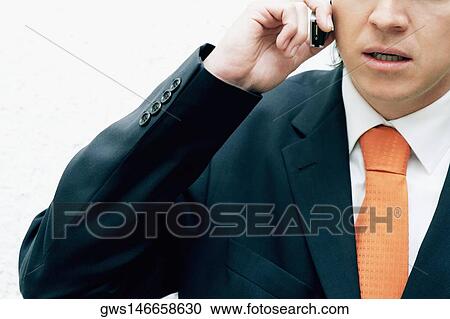 Close-up of a businessman talking on a mobile phone View Large Photo Image Stock Image - Close-up of a businessman talking on a mobile phone. Fotosearch