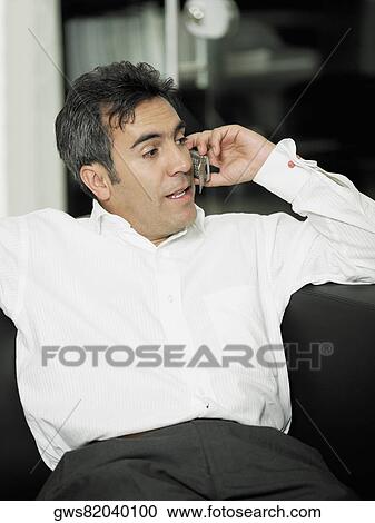 Close-up of a businessman talking on a mobile phone View Large Photo Image Stock Image - Close-up of a businessman talking on a mobile phone. Fotosearch