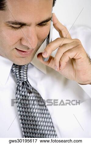 Close-up of a businessman talking on a mobile phone View Large Photo Image Stock Photo - Close-up of a businessman talking on a mobile phone. Fotosearch