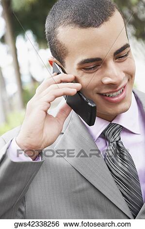Stock Photograph - Close-up of a businessman talking on a mobile phone. Fotosearch