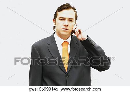 Close-up of a businessman talking on a mobile phone View Large Photo Image Stock Photography - Close-up of a businessman talking on a mobile phone. Fotosearch