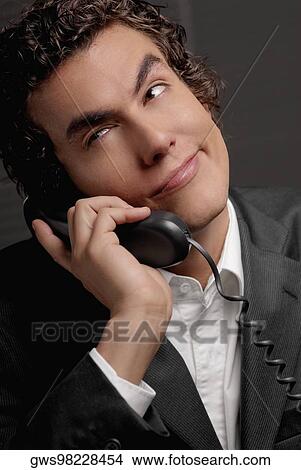 Close-up of a businessman talking on the telephone View Large Photo Image Picture - Close-up of a businessman talking on the telephone. Fotosearch