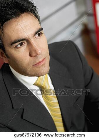 Close-up of a businessman thinking View Large Photo Image Stock Photograph - Close-up of a businessman thinking. Fotosearch