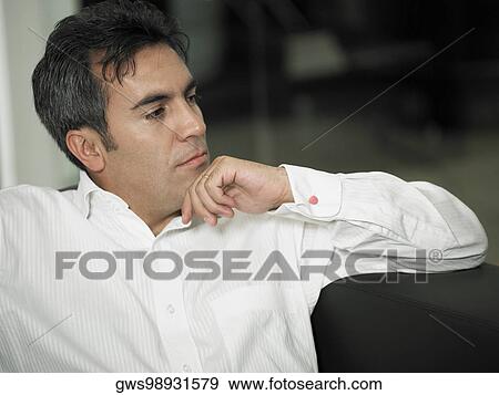 Close-up of a businessman thinking with his hand on his chin View Large Photo Image Stock Photo - Close-up of a businessman thinking with his hand on his chin. Fotosearch