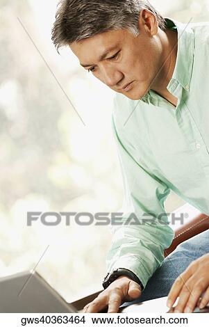 Close-up of a businessman using a laptop View Large Photo Image Picture - Close-up of a businessman using a laptop. Fotosearch