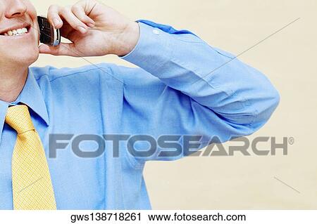 Close-up of a businessman using a mobile phone View Large Photo Image Stock Image - Close-up of a businessman using a mobile phone. Fotosearch
