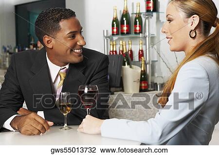 Close-up of a businessman with a businesswoman sitting in a bar View Large Photo Image Stock Image - Close-up of a businessman with a businesswoman sitting in a bar. Fotosearch