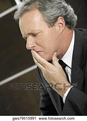 Close-up of a businessman with his hand over his mouth View Large Photo Image Stock Image - Close-up of a businessman with his hand over his mouth. Fotosearch