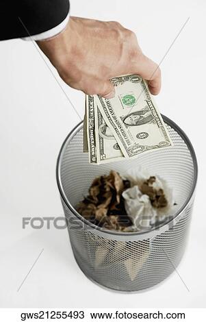 Close-up of a businessman's throwing paper currency in a wastepaper basket View Large Photo Image Stock Image - Close-up of a businessman's throwing paper currency in a wastepaper basket. Fotosearch