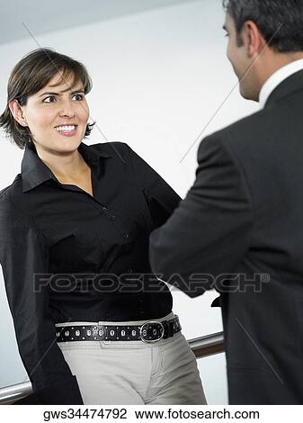 Close-up of a businesswoman and a businessman talking to each other View Large Photo Image Stock Image - Close-up of a businesswoman and a businessman talking to each other. Fotosearch