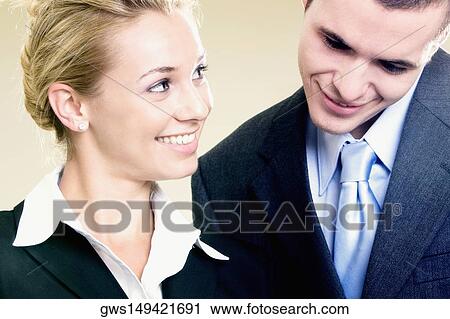 Close-up of a businesswoman looking at a businessman View Large Photo Image Stock Image - Close-up of a businesswoman looking at a businessman. Fotosearch