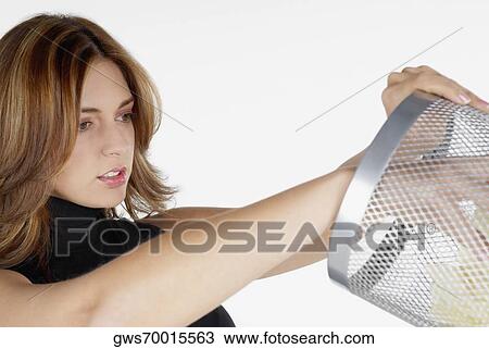 Close-up of a businesswoman looking inside of a wastepaper basket View Large Photo Image Stock Image - Close-up of a businesswoman looking inside of a wastepaper basket. Fotosearch