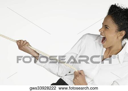 Close-up of a businesswoman pulling a rope and laughing View Large Photo Image Stock Image - Close-up of a businesswoman pulling a rope and laughing. Fotosearch
