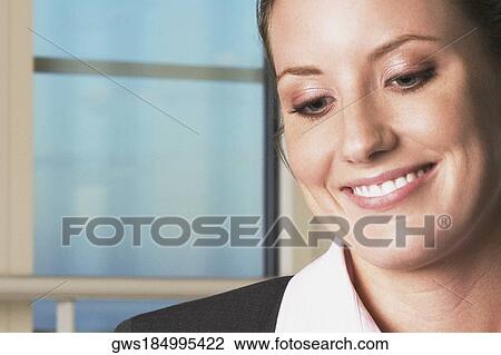 Stock Image - Close-up of a businesswoman smiling. Fotosearch