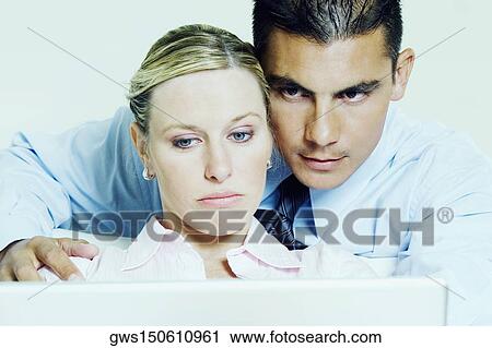 Close-up of a businesswoman using a laptop with a businessman View Large Photo Image Stock Image - Close-up of a businesswoman using a laptop with a businessman. Fotosearch