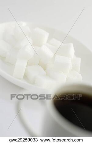 Close-up of a cup of black tea with sugar cubes View Large Photo Image Stock Image - Close-up of a cup of black tea with sugar cubes. Fotosearch