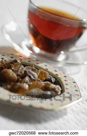 Close-up of a cup of black tea with snacks View Large Photo Image Stock Photo - Close-up of a cup of black tea with snacks. Fotosearch