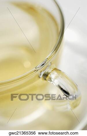 Close-up of a cup of herbal tea on a saucer View Large Photo Image Stock Photograph - Close-up of a cup of herbal tea on a saucer. Fotosearch