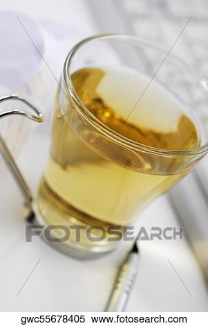 Close-up of a cup of herbal tea with a pen View Large Photo Image Stock Photography - Close-up of a cup of herbal tea with a pen. Fotosearch