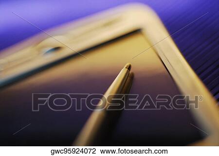 Stock Image - Close-up of a digitized pen on an electronic organizer. Fotosearch