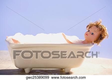 Close-up of a doll in a bathtub View Large Photo Image Stock Photo - Close-up of a doll in a bathtub. Fotosearch