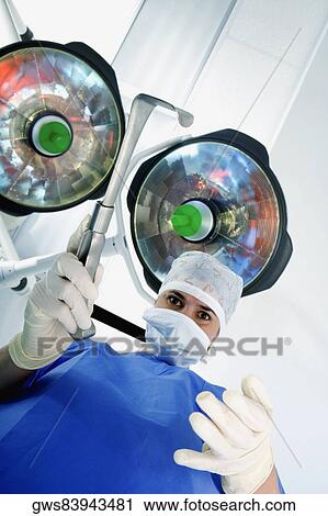 Close-up of a female surgeon holding a surgical equipment View Large Photo Image Stock Image - Close-up of a female surgeon holding a surgical equipment. Fotosearch