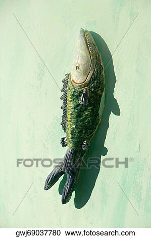 Close-up of a fish carved on the wall View Large Photo Image Stock Image - Close-up of a fish carved on the wall. Fotosearch