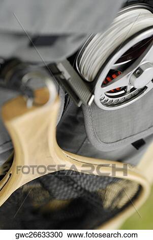 Stock Image - Close-up of a fishing net and a fishing reel. Fotosearch
