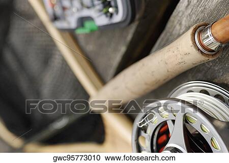 Stock Image - Close-up of a fishing reel and a fishing rod. Fotosearch