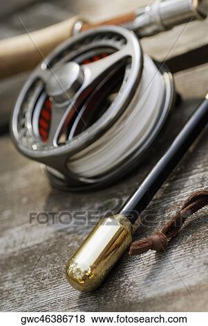 Stock Photo - Close-up of a fishing reel and two fishing rods. Fotosearch