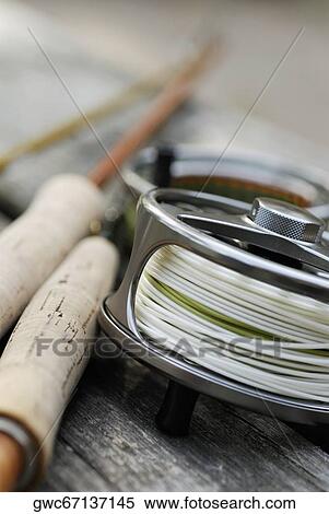 Stock Photography - Close-up of a fishing reel and two fishing rods. Fotosearch