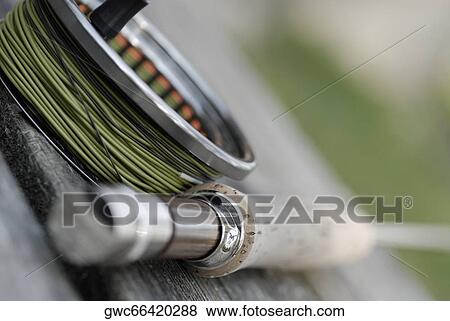 Close-up of a fishing rod and a fishing reel View Large Photo Image Stock Photo - Close-up of a fishing rod and a fishing reel. Fotosearch