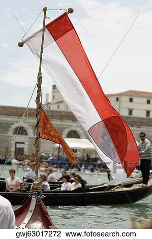 Close-up of a flag on a gondola with a group of people behind in another gondola, Venice, Veneto, Italy View Large Photo Image Stock Image - Close-up of a flag on a gondola with a group of people behind in another gondola, Venice, Veneto, Italy. Fotosearch