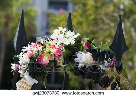 Close-up of a gate decorated with flowers View Large Photo Image Stock Image - Close-up of a gate decorated with flowers. Fotosearch