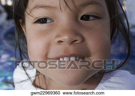 Stock Image - Close-up of a girl grinning. Fotosearch