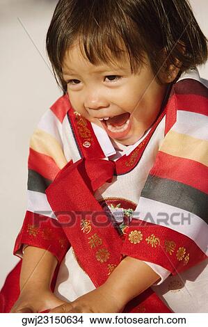 Close-up of a girl in traditional clothing laughing View Large Photo Image Picture - Close-up of a girl in traditional clothing laughing. Fotosearch